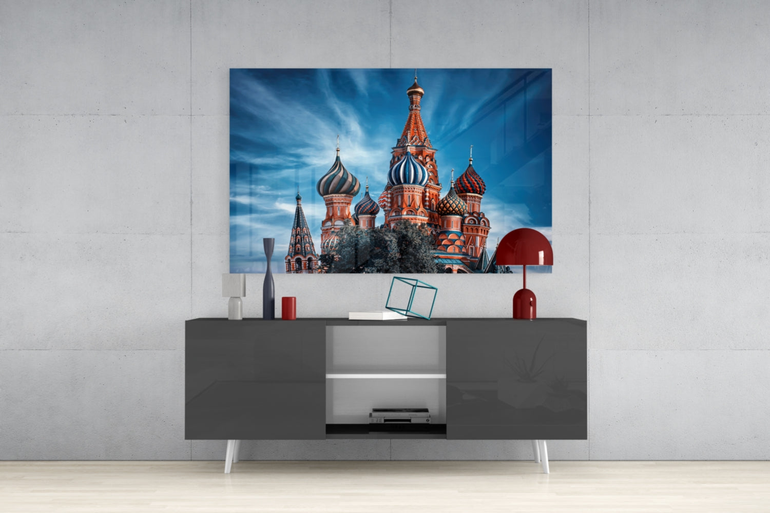 St. Basil's Cathedral glass wall art displaying red onion domes and blue sky, mounted above dark gray media console in modern interior.