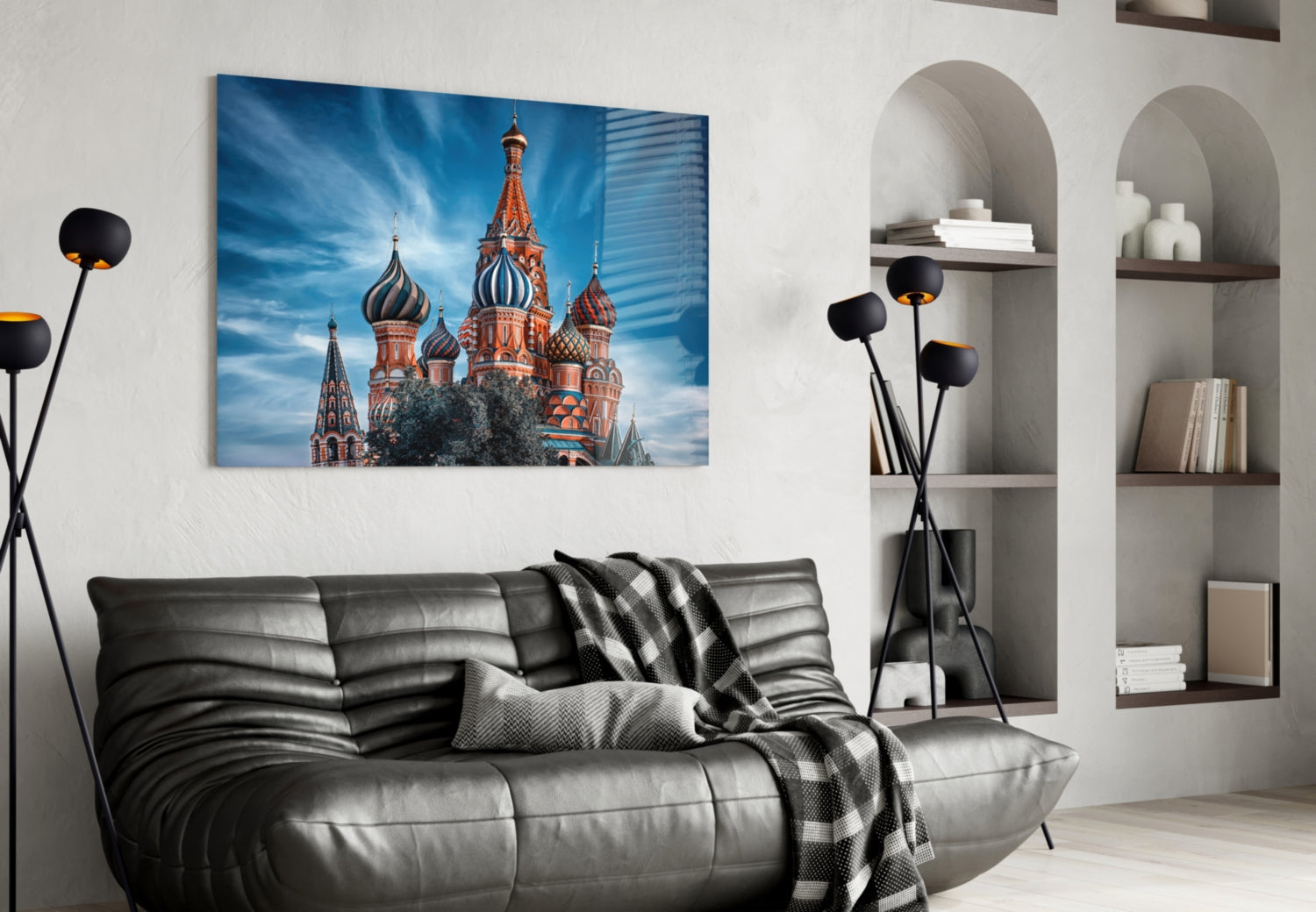 St. Basil's Cathedral glass wall art hung above gray leather sofa in modern living room with white shelving.