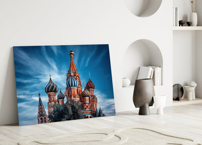 St. Basil's Cathedral glass wall art leaning against white wall in minimalist room with sand and decorative objects.