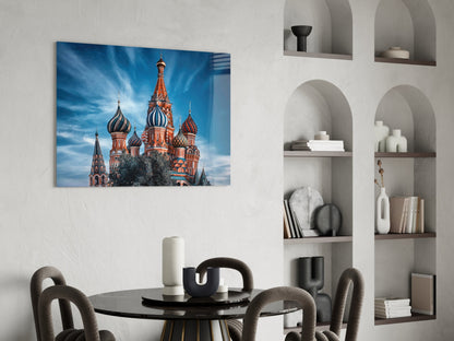 St. Basil's Cathedral glass wall art hanging above a round black table with gray chairs in a modern interior setting.