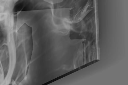 Close-up of frosted glass panel featuring swirling smoke patterns in grayscale tones with dark frame edge visible.
