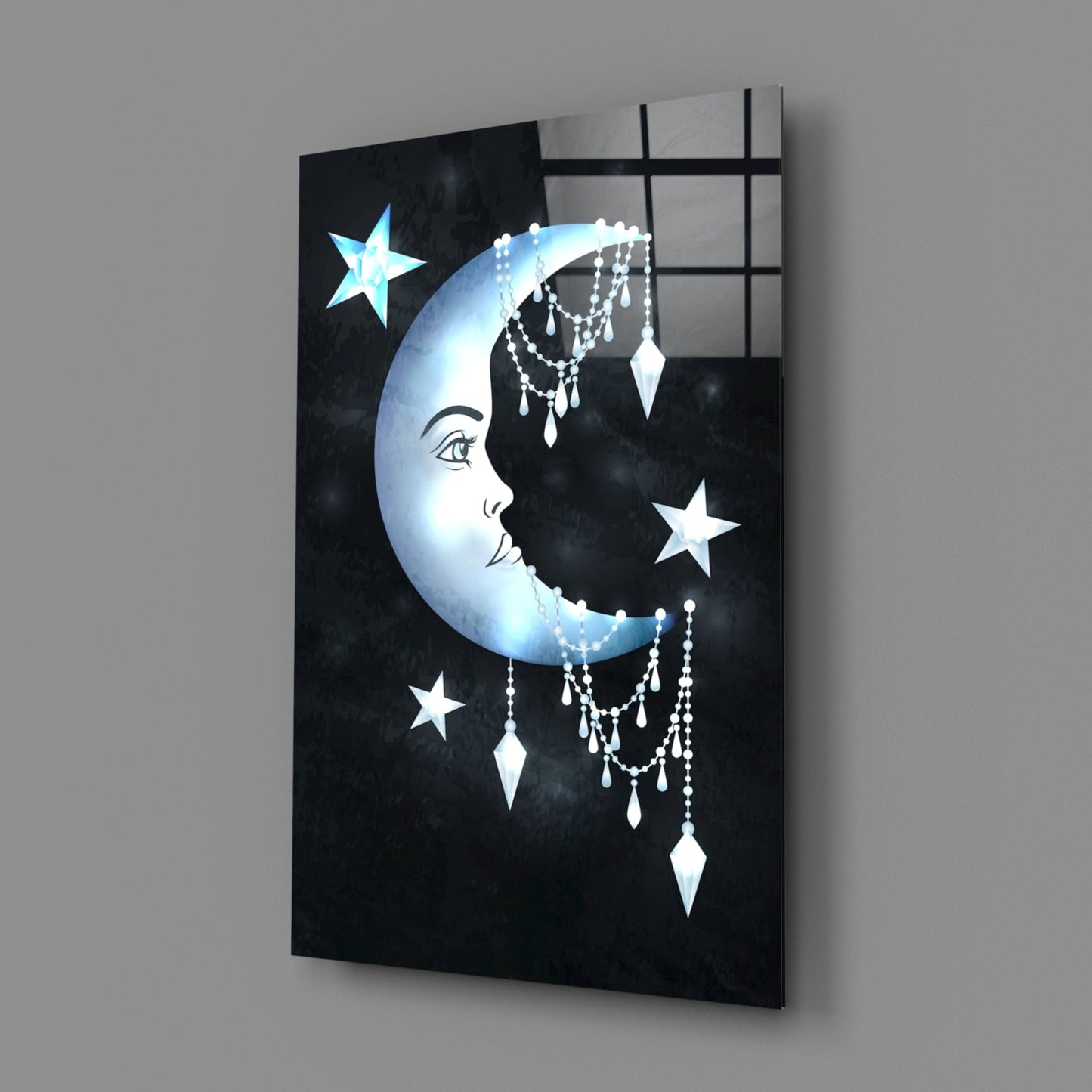 Angled view of black glass wall art featuring a luminous crescent moon with facial profile, dangling crystal beads, white stars, and grid pattern overlay.