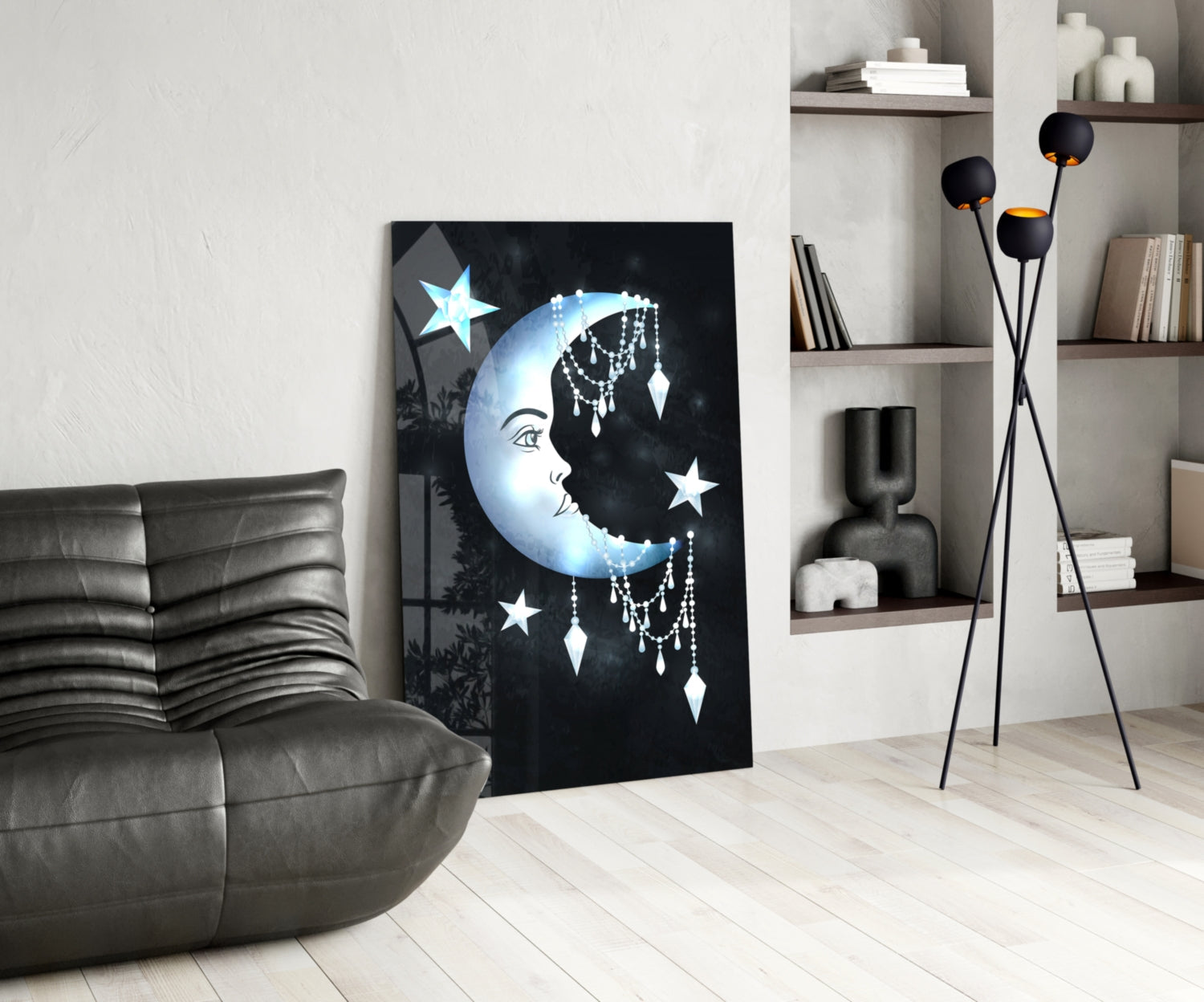 Moon Star Glass Wall Art displayed on floor against white wall in modern living room with gray sofa and shelving.
