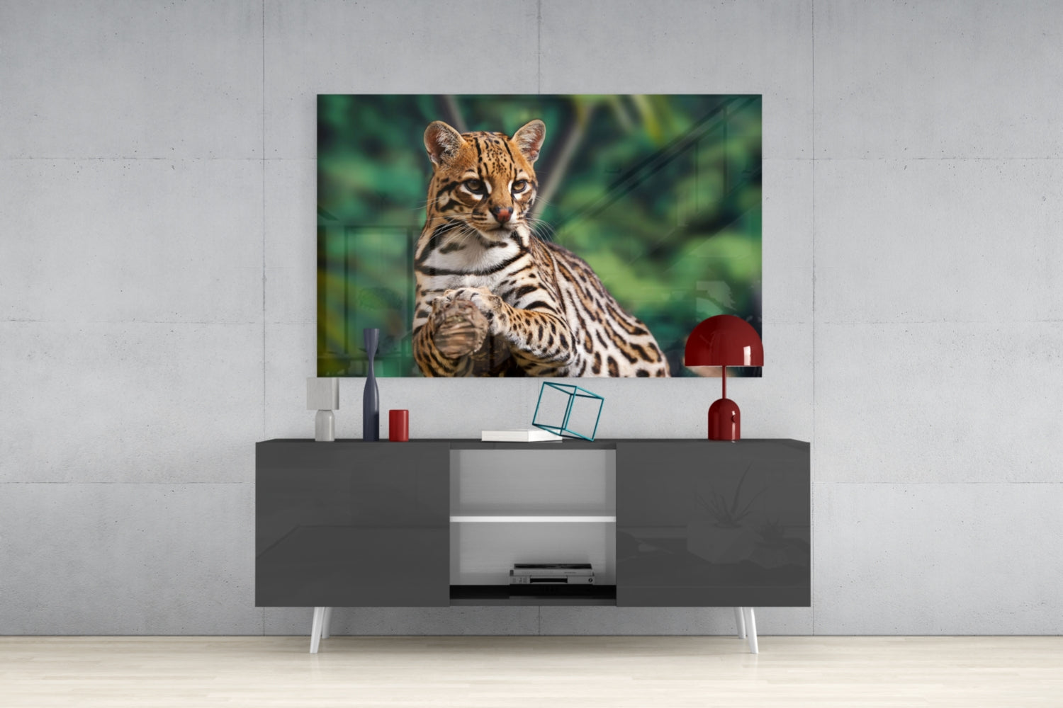 Cheetah glass wall art mounted above gray media console, displaying spotted big cat against green blurred background.