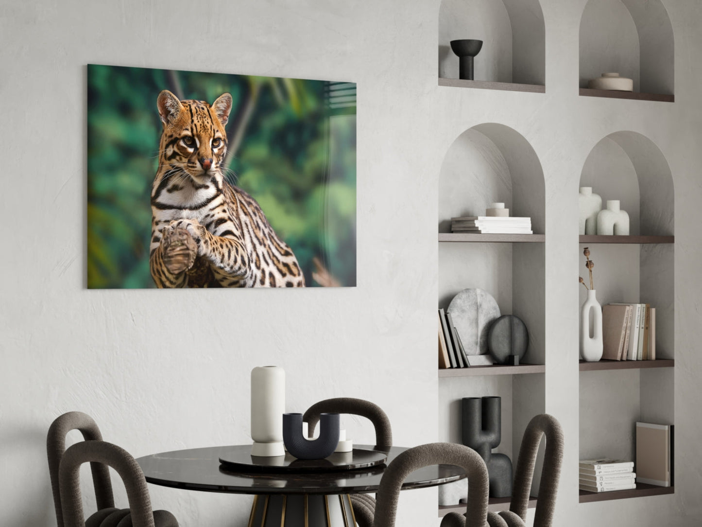 Glass wall art depicting a spotted wild cat with green foliage background, mounted in modern dining room above black table.
