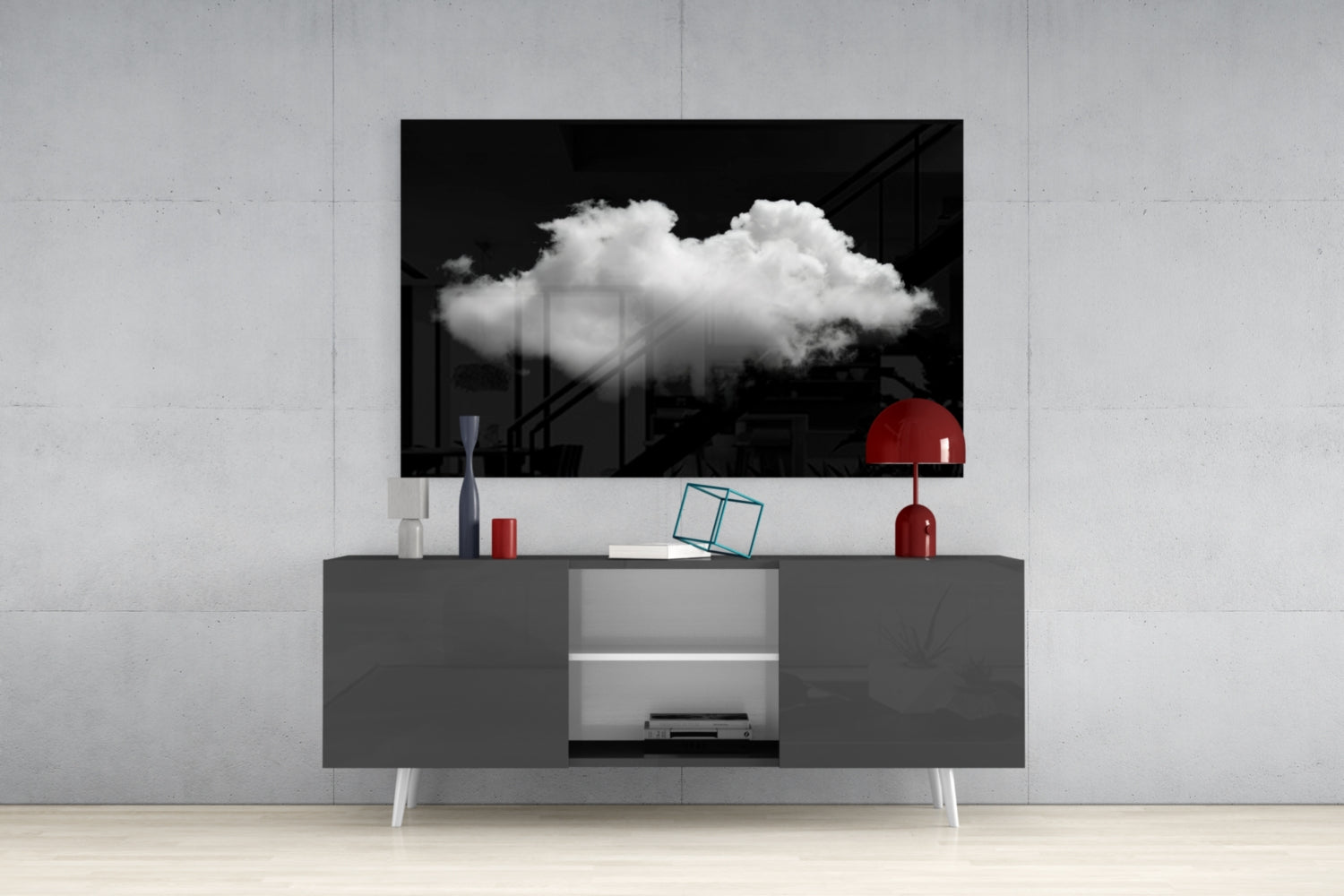 Black and white cloud glass wall art displayed above gray media console with red lamp and decorative objects in modern interior setting.