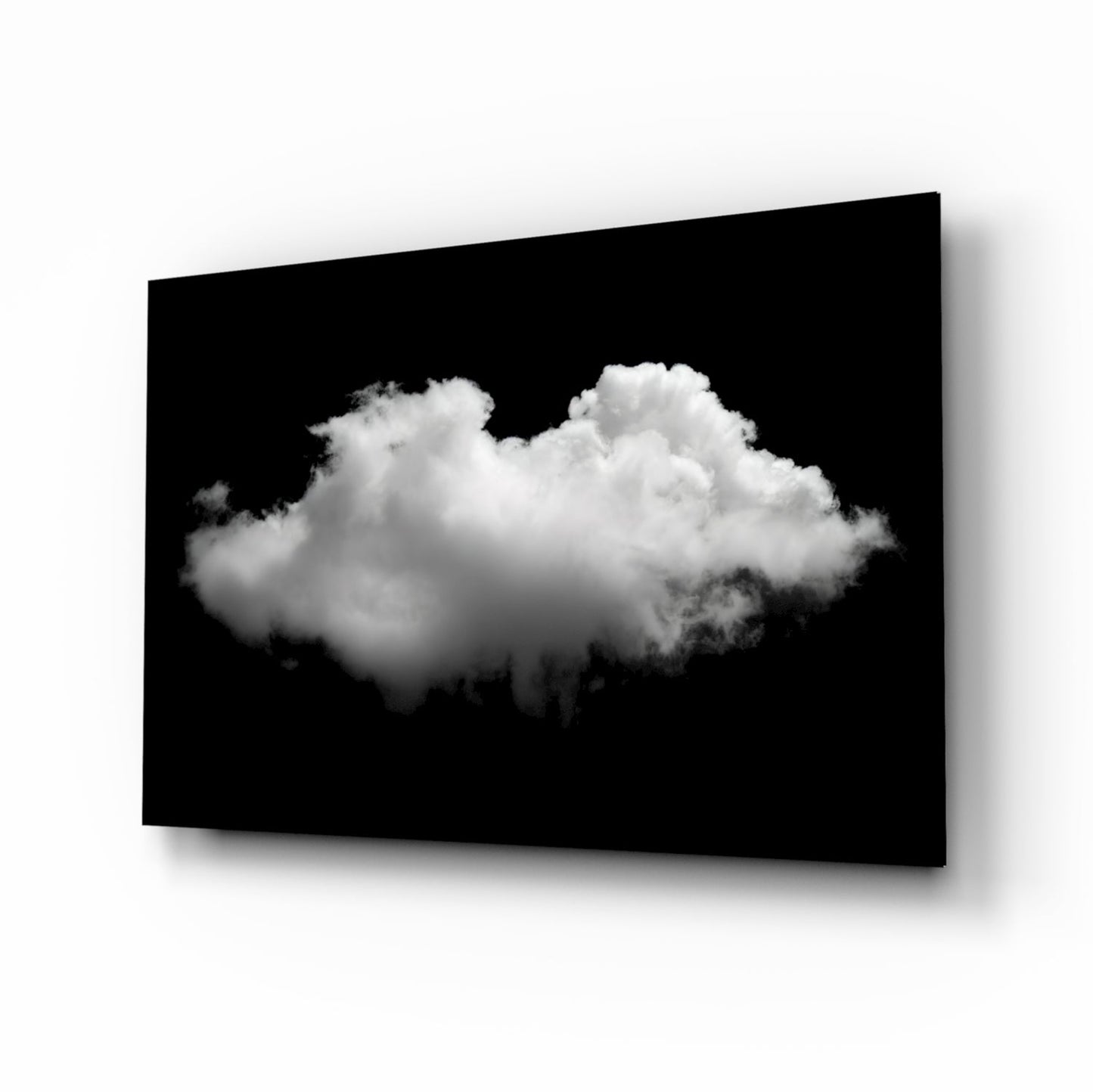 Single fluffy white cloud centered against black background on angled glass panel with shadow.