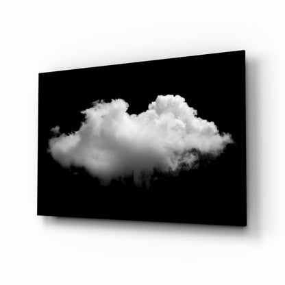 Single fluffy white cloud centered against black background on angled glass panel with shadow.