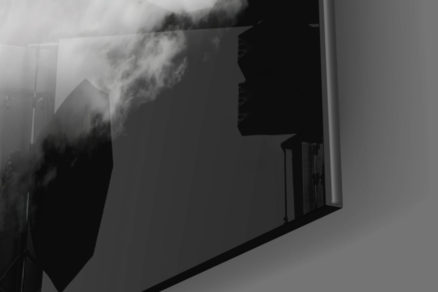 Black and white landscape photograph printed on frosted glass panel mounted on white wall, showing misty mountains.