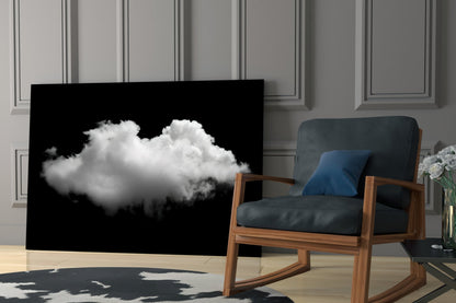 Black glass panel displaying a white fluffy cloud against dark background, positioned in modern interior beside wooden chair.