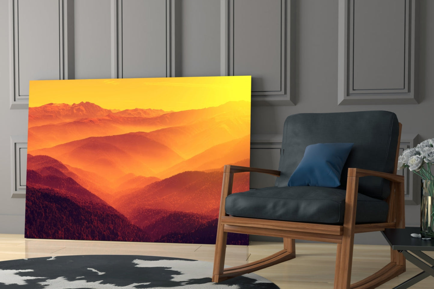 Warm Landscape Glass Wall Art displaying golden sunset over layered mountains displayed in modern living room with wooden chair.