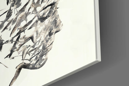Close-up of textured glass wall art featuring black and gray brushstroke details against white background, mounted on gray wall.