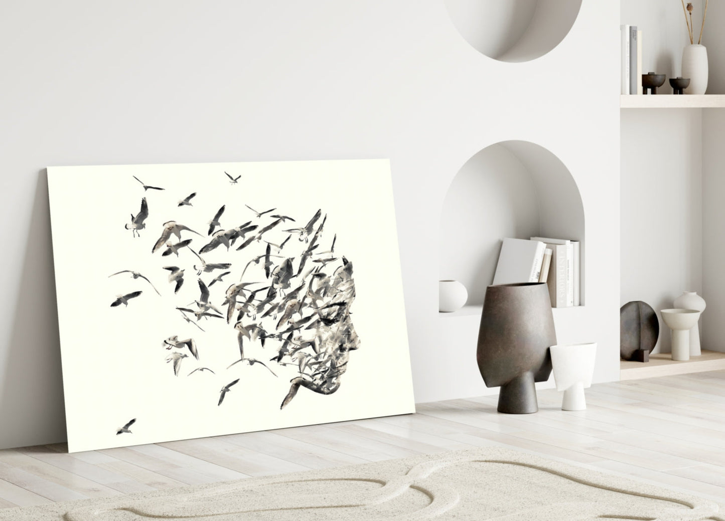 Modern minimalist interior with leaning glass artwork depicting a profile head dissolving into flying birds in black ink on white background.