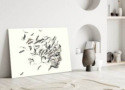 Modern minimalist interior with leaning glass artwork depicting a profile head dissolving into flying birds in black ink on white background.