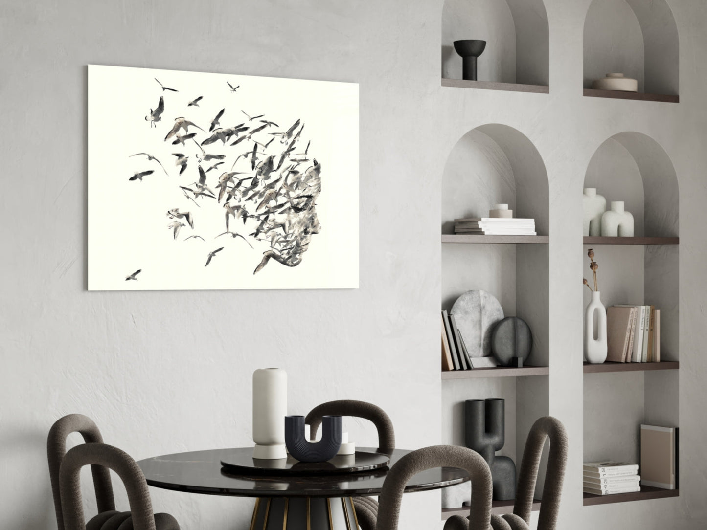 Glass wall art depicting birds dispersing from a human head silhouette in monochromatic sketch style, displayed above a dining table.