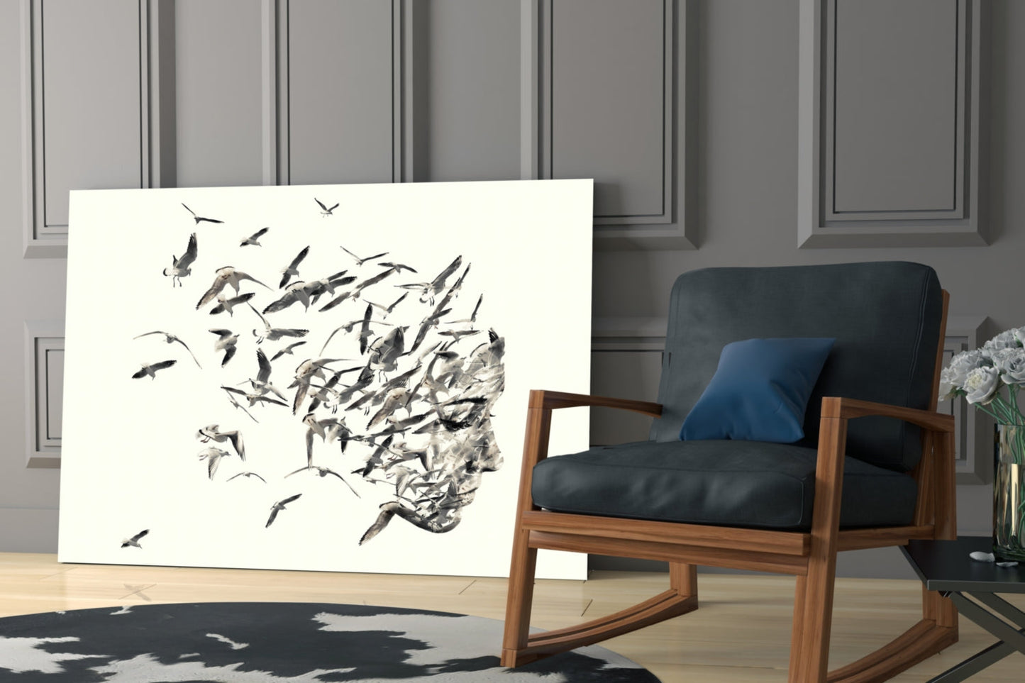 Modern living room interior featuring glass wall art with black ink drawing of birds dispersing from a human head silhouette.