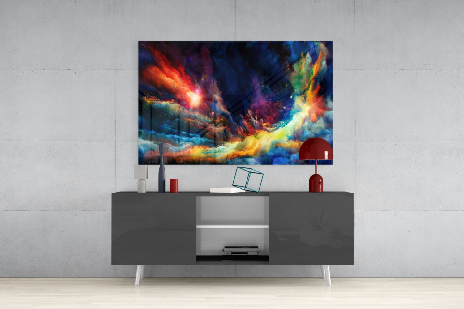 Vibrant multicolored abstract glass art displaying fiery reds, blues, and yellows mounted above a modern gray media console.