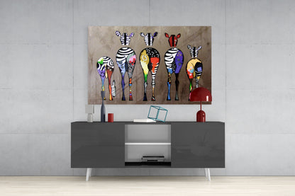 Colorful zebra glass art panel hung above a dark gray media console in a modern living room setting.