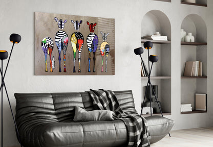 Colorful Zebras glass wall art displayed above a black leather sofa in a modern living room with arched shelving and decorative floor lamps.