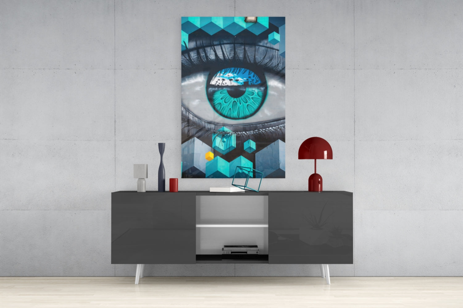 Turquoise eye glass art displayed on gray media console with decorative items in modern living room setting.