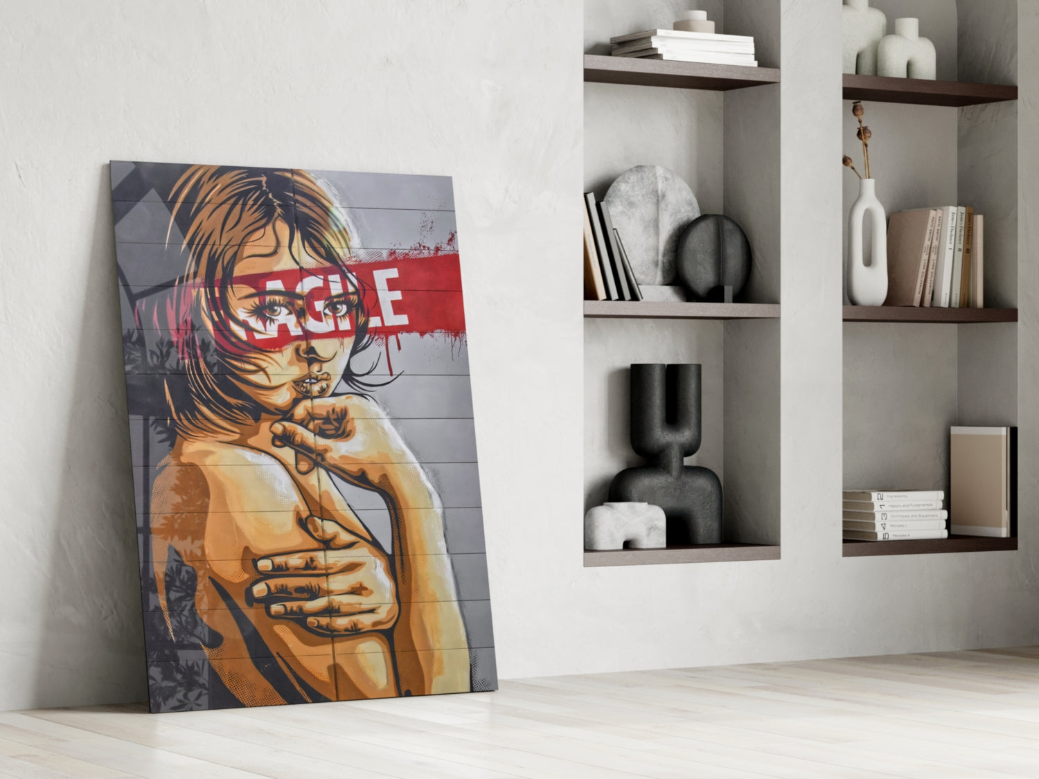 Glass wall art with portrait of girl in yellow and blue tones with red "RAGE" text, leaning against white wall beside shelving unit.