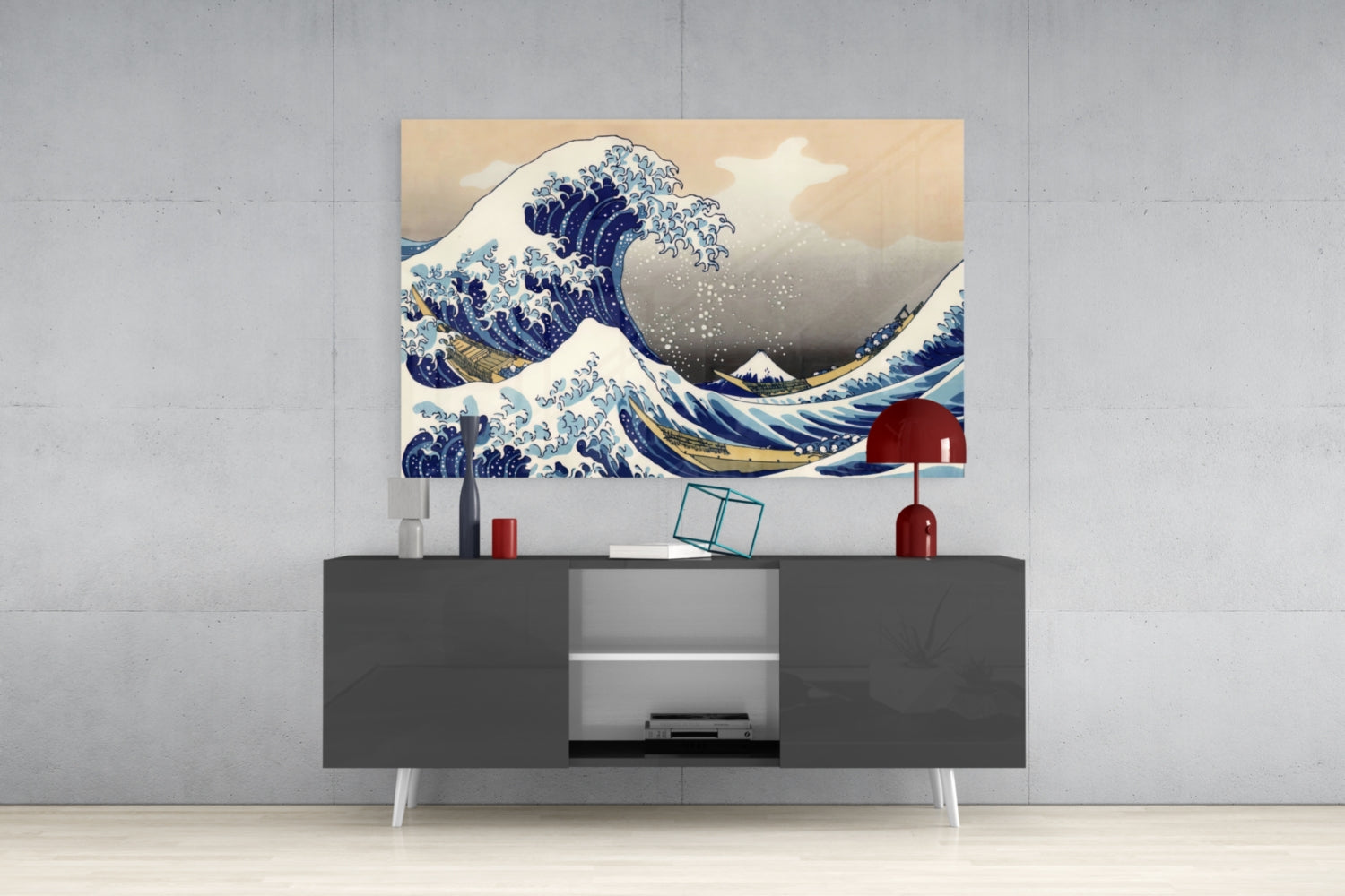 Modern living room interior featuring a mounted glass art print of Hokusai's Great Wave above a dark gray media console with white legs and decorative objects.