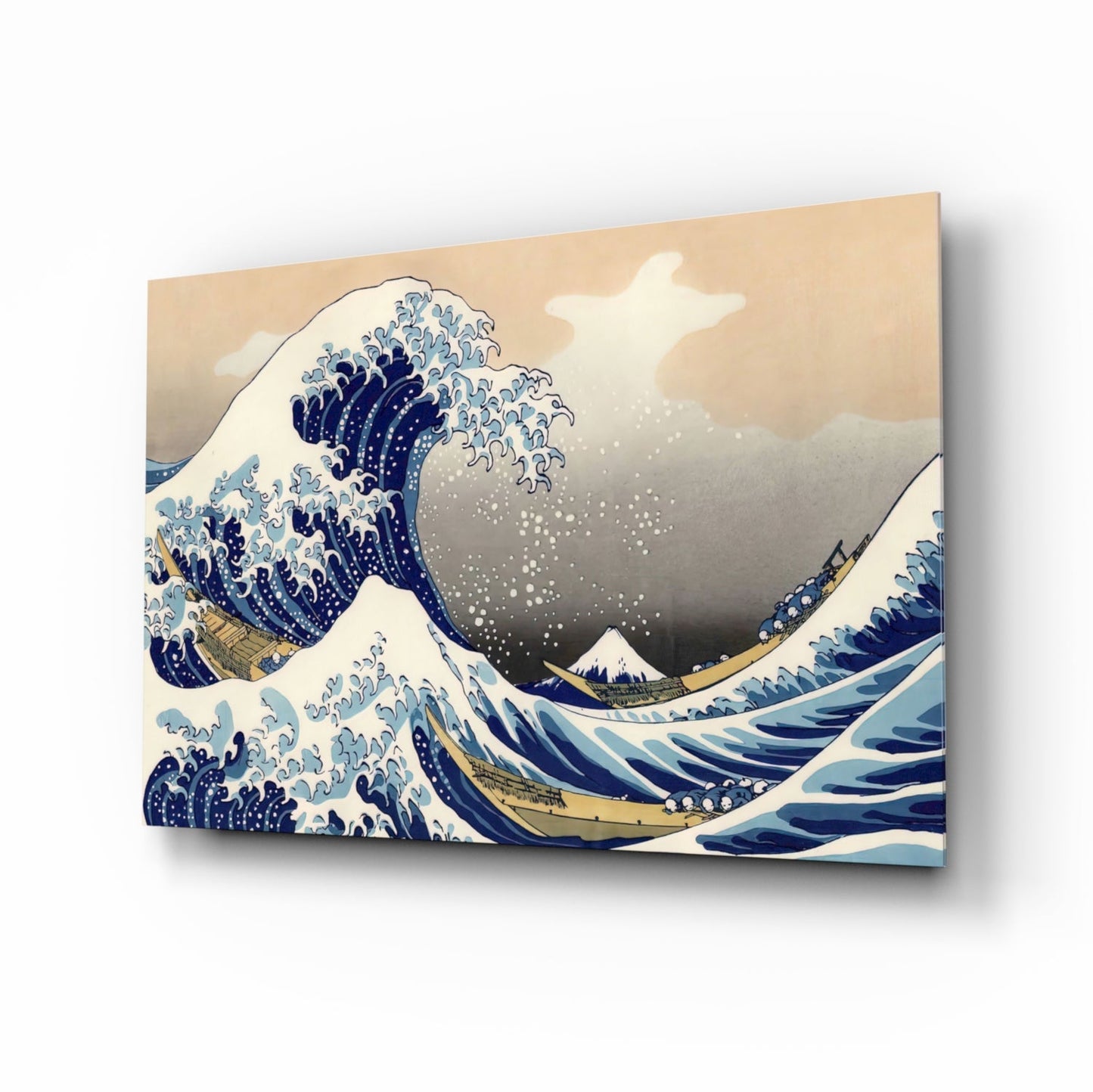Glass wall art print displayed at an angle showing Hokusai's Great Wave with blue and white waves, Mount Fuji, and cream background.
