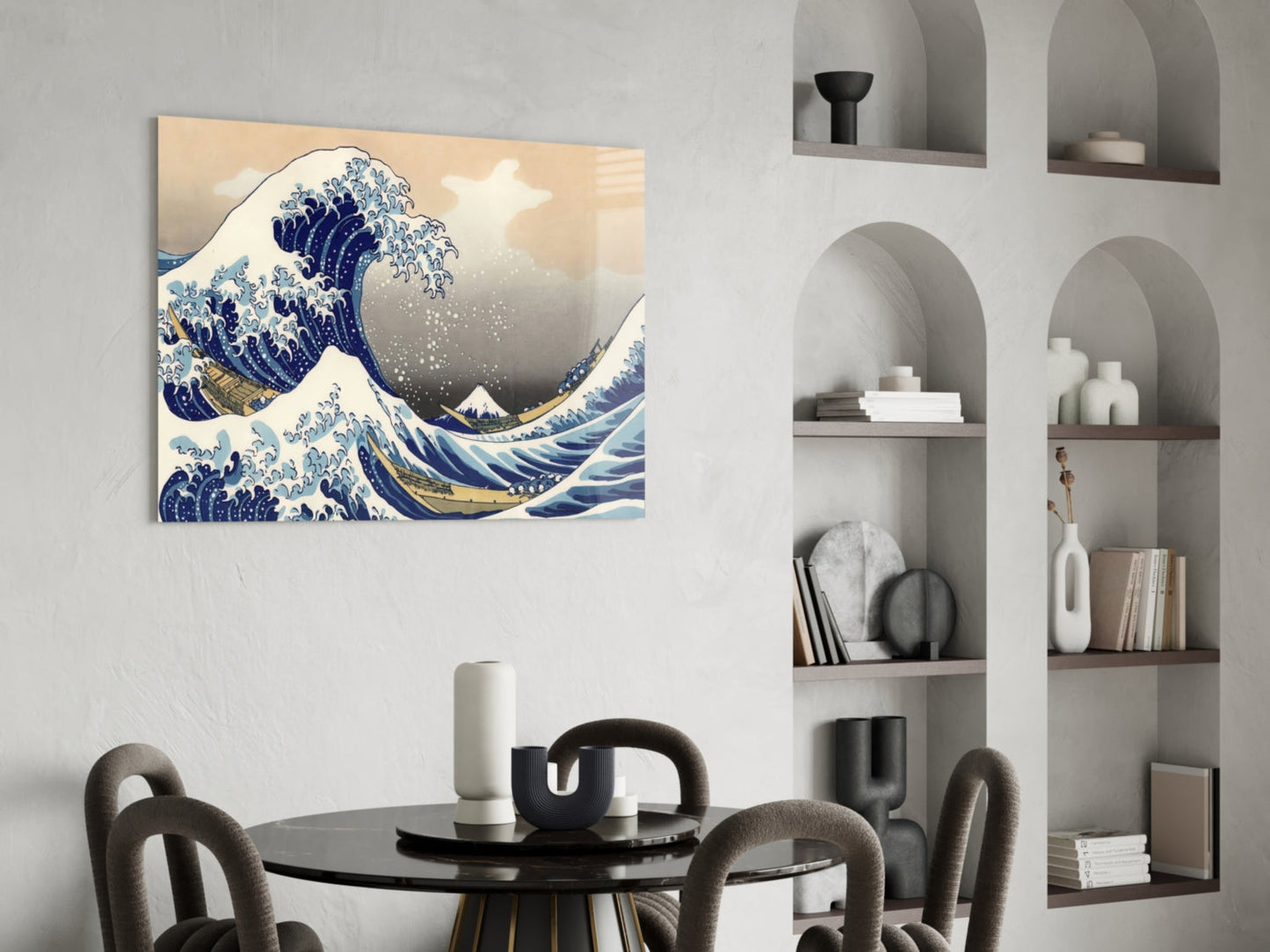 Glass wall art print of The Great Wave off Kanagawa displayed above a black dining table with gray chairs and white shelving unit.