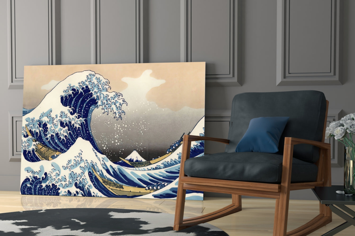 Glass wall art displaying Hokusai's Great Wave print in blue and cream tones, positioned beside a wooden rocking chair in a modern interior.