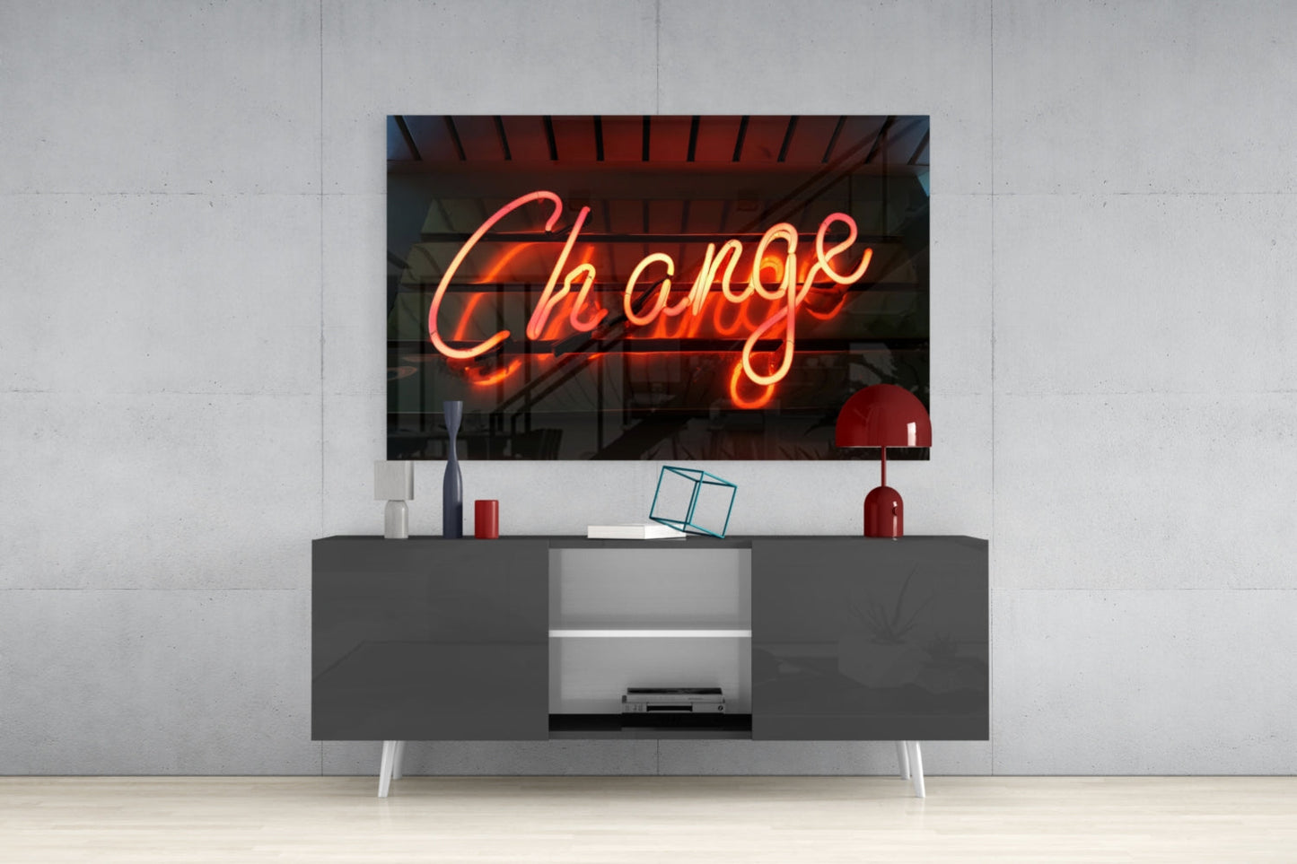 Neon "Change" glass wall art in red and orange displayed above a gray media console in a modern living room setting.