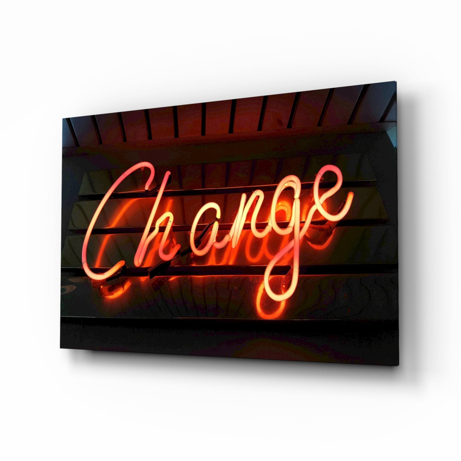 Neon glass wall art displaying "Change" in glowing red and orange cursive script against a dark wooden background with exposed beams.