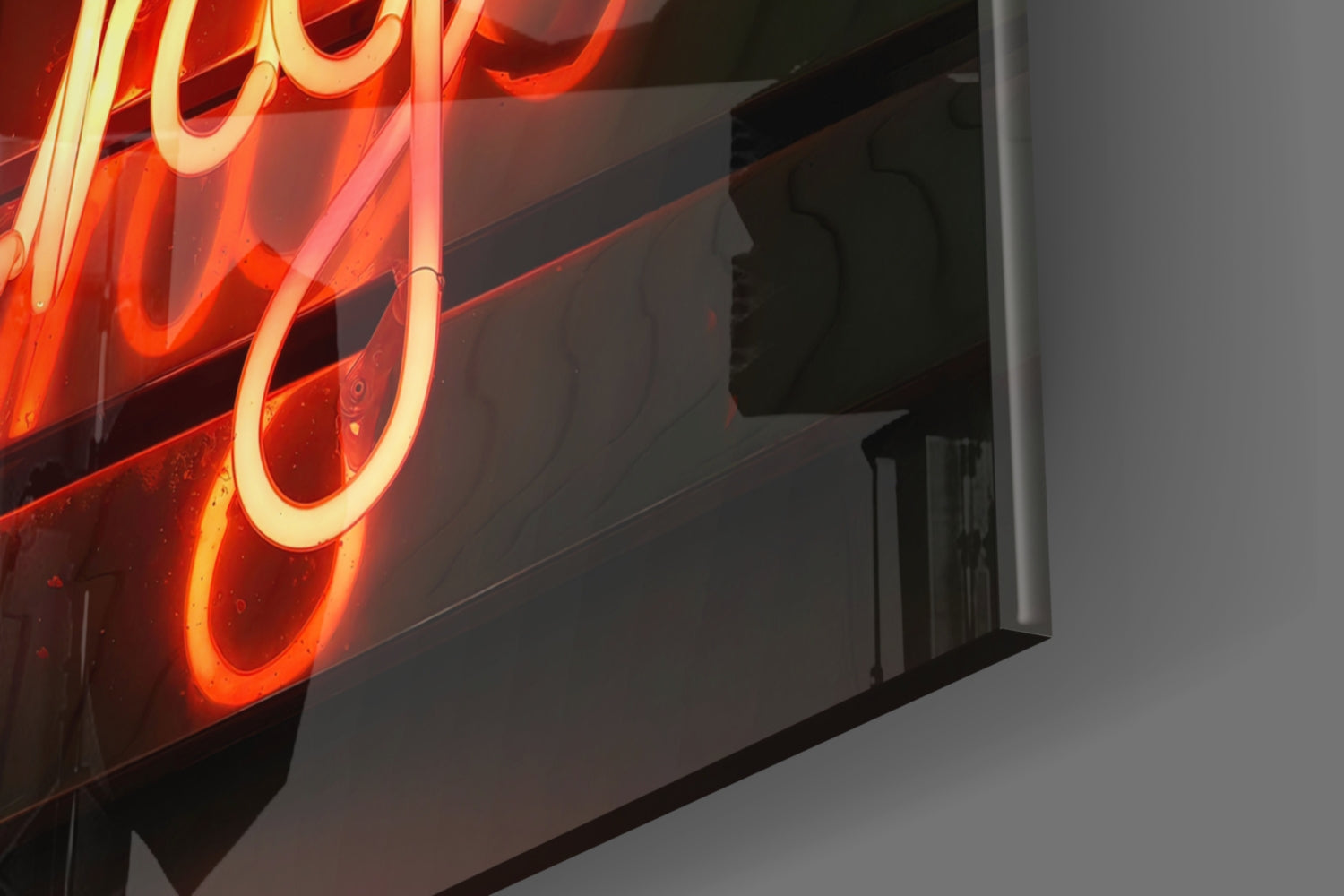 Glowing red and orange neon sign with curved tubing mounted on a dark building exterior against gray wall.