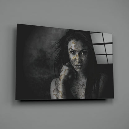 Black and white portrait of tattooed woman on glass wall art panel with window grid reflection on right side.