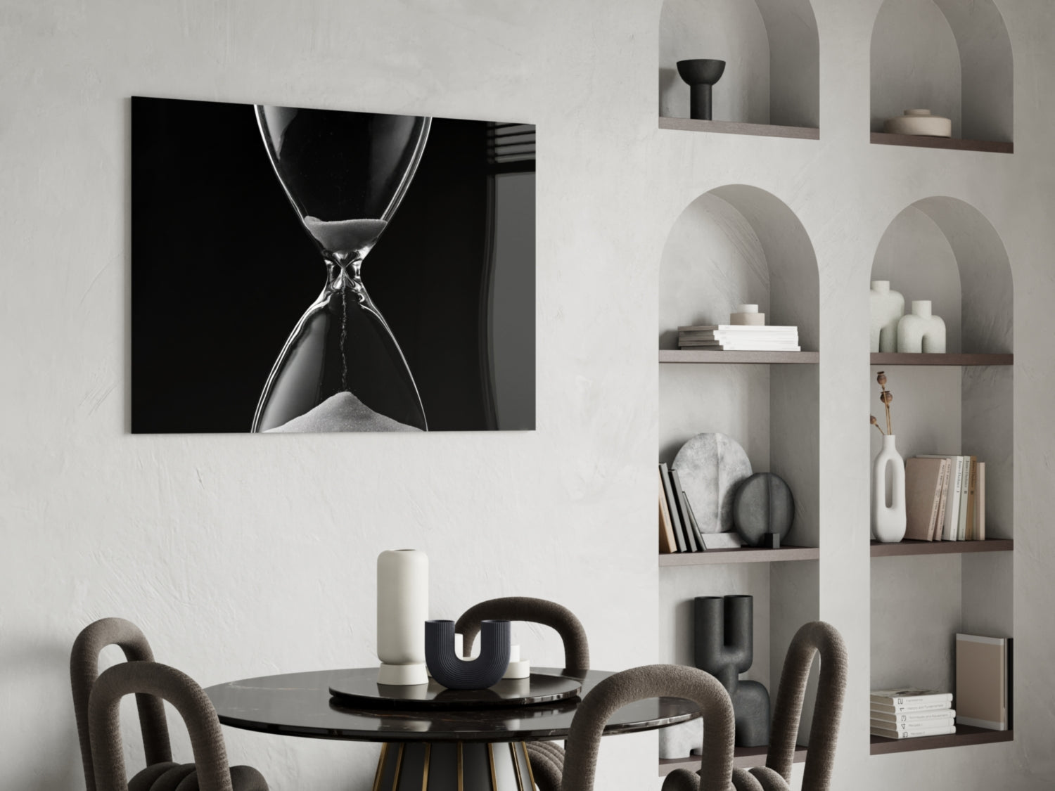 Black and white hourglass canvas art displayed above a round black dining table with upholstered chairs and styled wall shelving.
