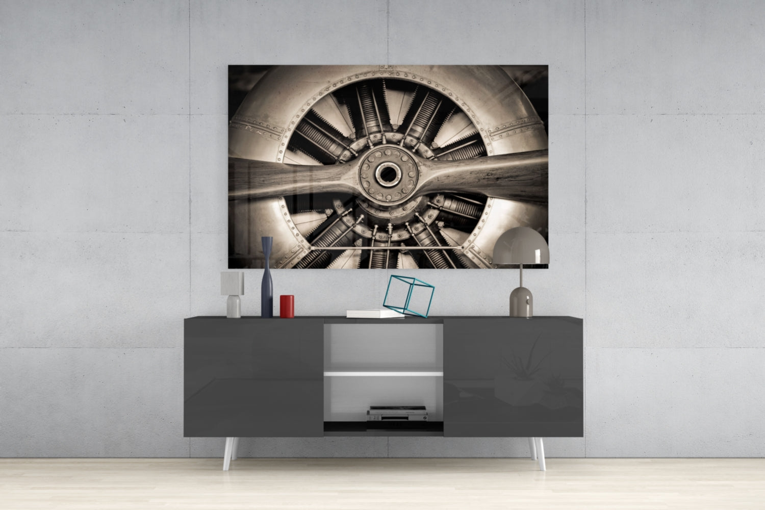 Sepia-toned aircraft propeller and engine mounted on white wall above gray media console in modern interior setting.
