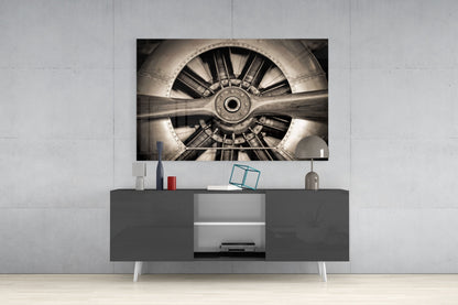Sepia-toned aircraft propeller and engine mounted on white wall above gray media console in modern interior setting.