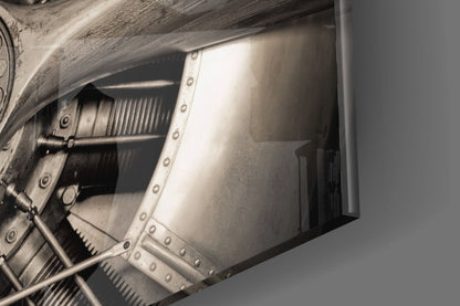 Close-up detail of metallic propeller and riveted aircraft fuselage panel against grey background.
