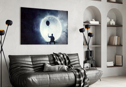 Glass wall art depicting a silhouetted figure on a bench gazing at a glowing moon against a starry night sky.