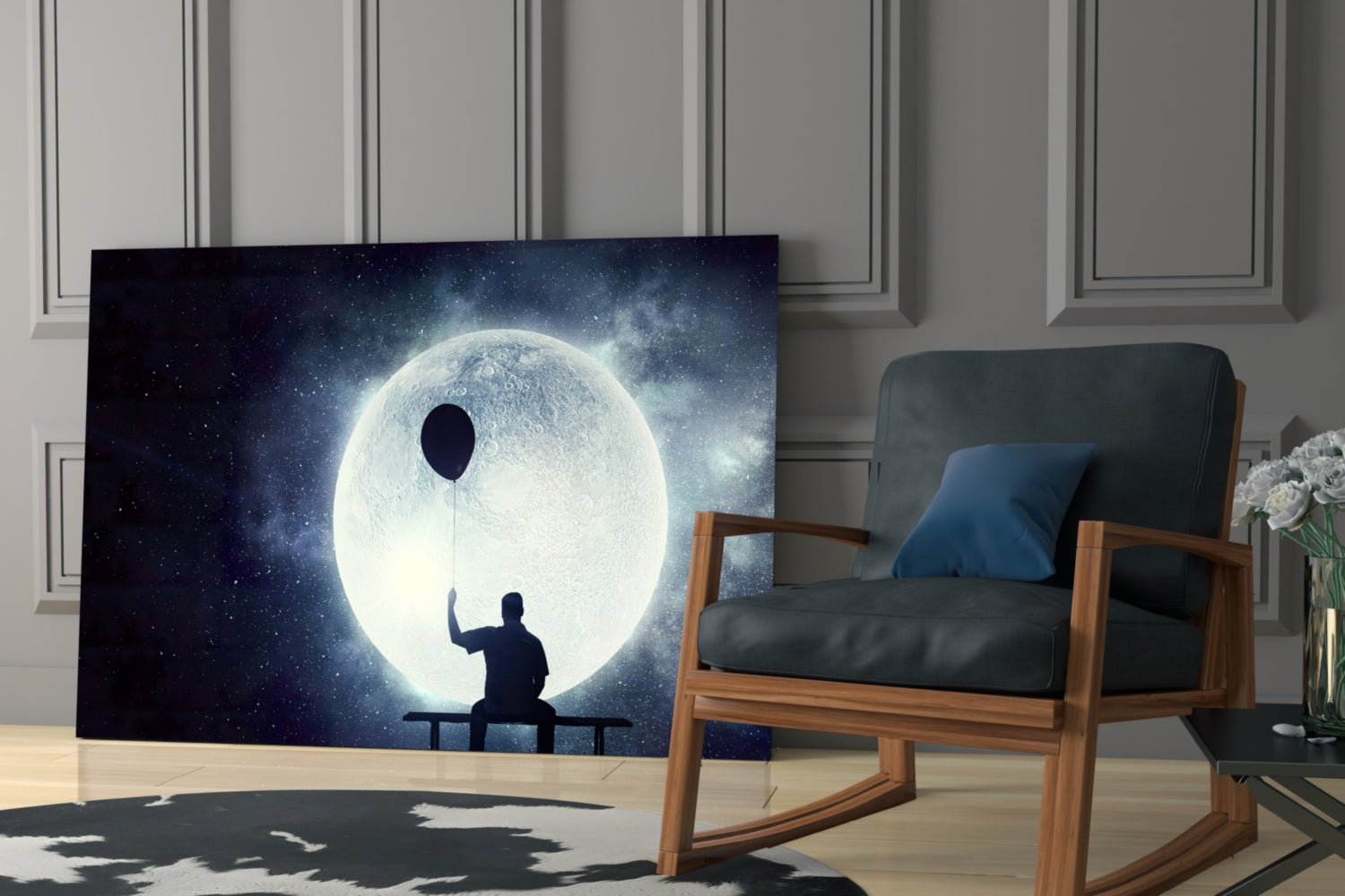 Silhouetted figure sitting on bench holding balloon string toward glowing moon in starry night sky glass wall art displayed in modern living room.