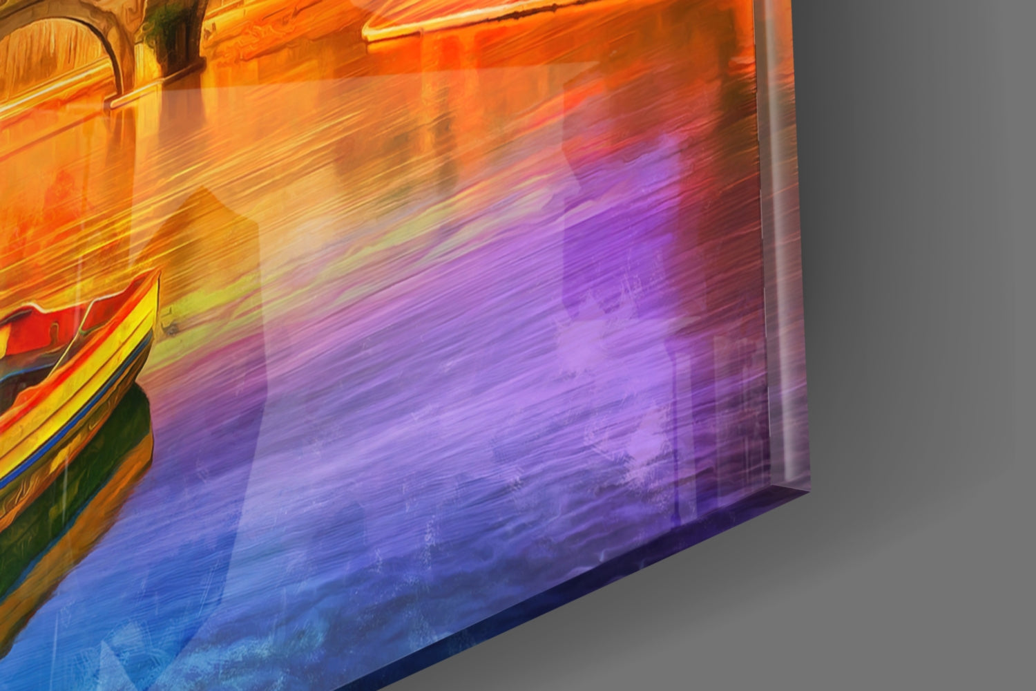 Close-up angled view of colorful glass wall art transitioning from orange and yellow at top through purple to blue at bottom, with partial architectural detail visible on left edge.