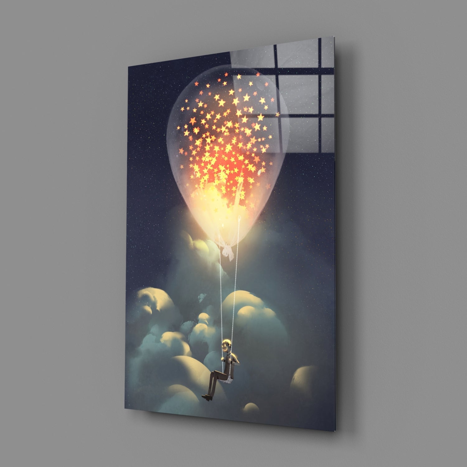 Angled view of glass wall art depicting a figure on clouds holding a glowing balloon releasing golden stars against a starry night sky.
