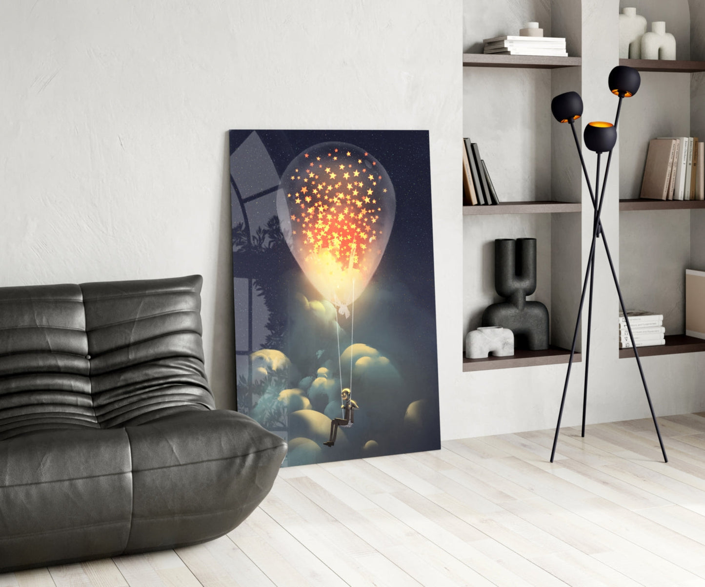 Modern living room interior featuring glass wall art depicting a glowing bulb with golden stars above clouds and a silhouetted figure below.