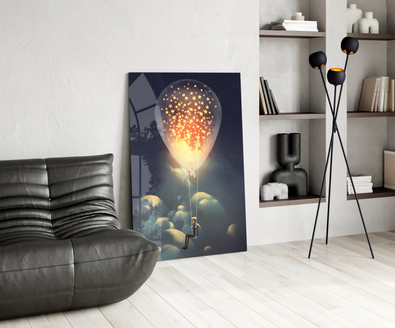 Modern living room interior featuring glass wall art depicting a glowing bulb with golden stars above clouds and a silhouetted figure below.