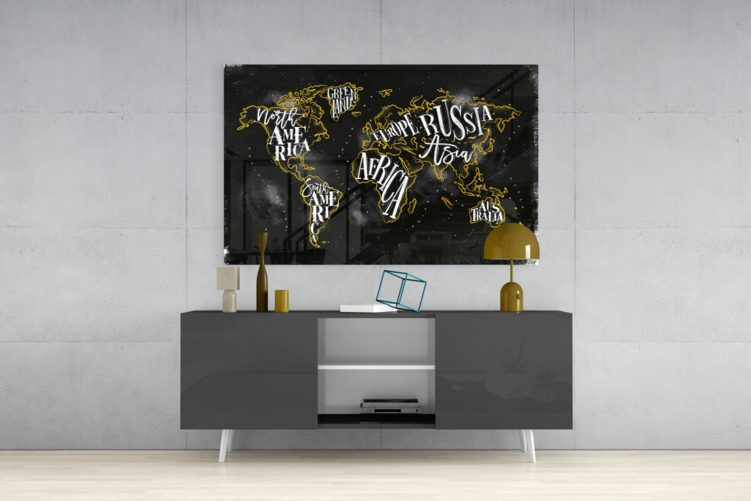 Black and gold world map canvas displayed above gray media console with gold accents in modern living room setting.