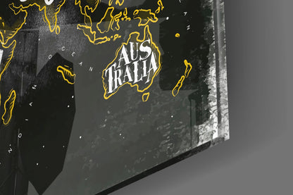 Close-up angled view of a modern world map with yellow outlined continents and "Australia" text on dark background, displayed on textured surface.