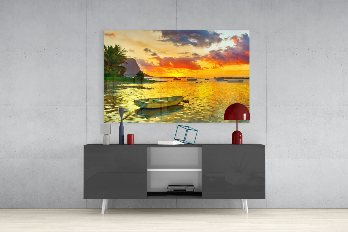 Sunset Fishing canvas print displayed above gray TV console with white legs and decorative red lamp.