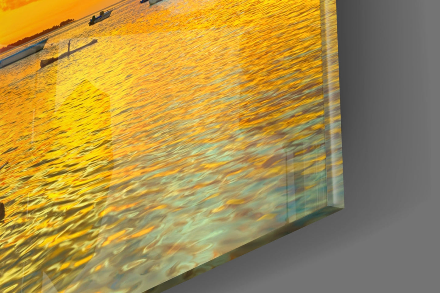 Angled close-up view of a framed photograph showing golden sunset light reflecting on rippled water.