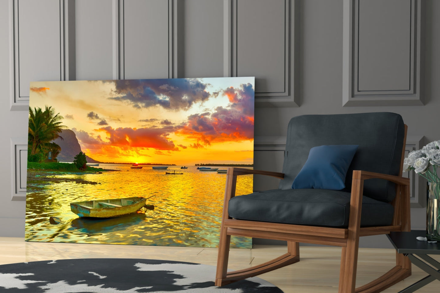 Canvas print of golden sunset over tropical bay with fishing boats displayed in modern living room next to wooden chair.