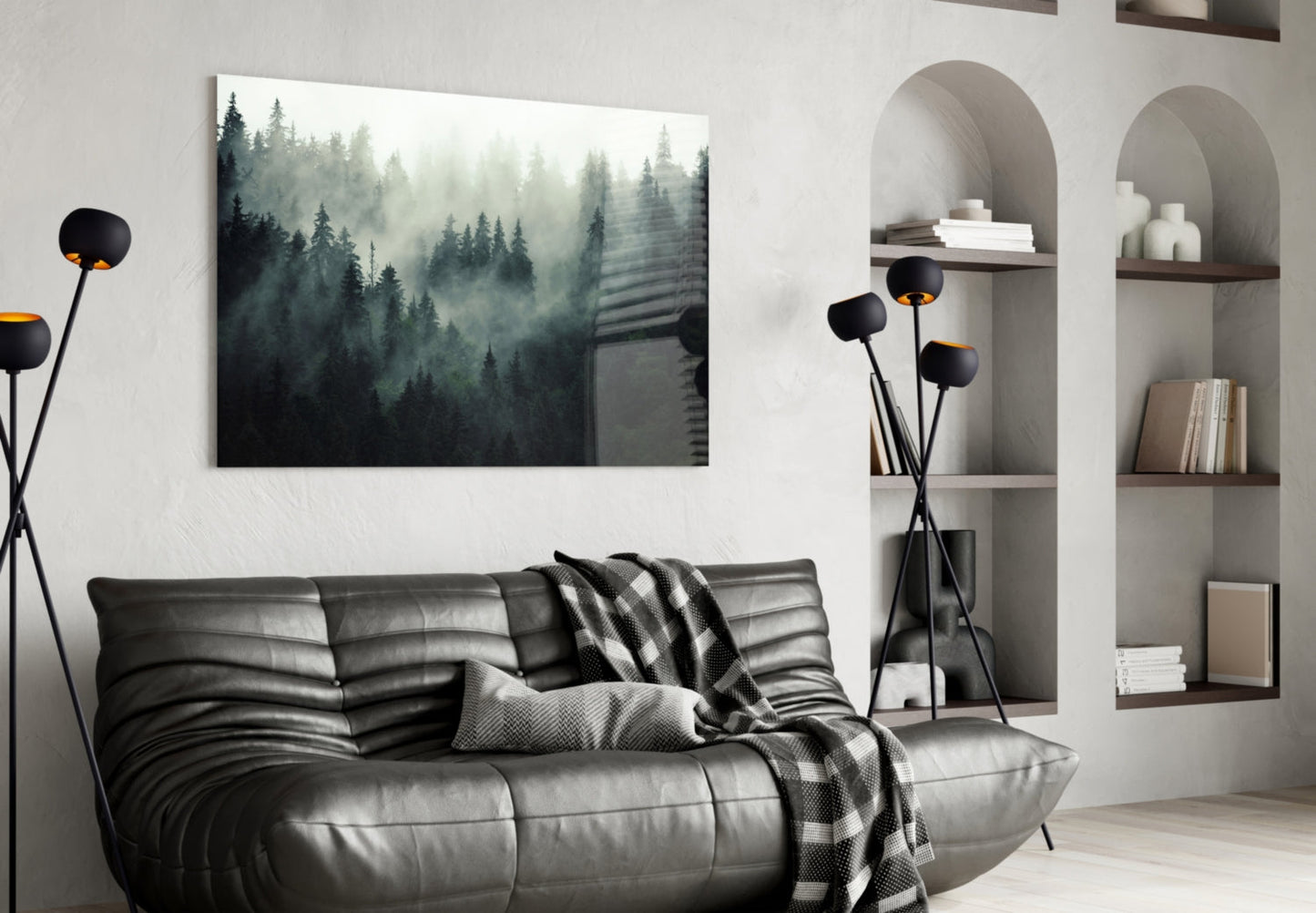 Moody forest landscape glass wall art hanging above black leather sofa in modern living room interior.