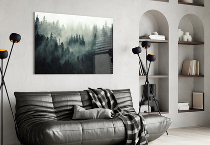 Moody forest landscape glass wall art hanging above black leather sofa in modern living room interior.